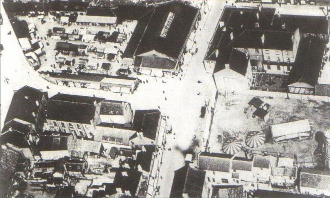 Aerial view of the town centre c1920 The Blue Bell is top right and opposite is the market hall of 1906, top left. On the left centre are  the 2nd & 3rd Wesleyan Chapels at the top of Market Hill.